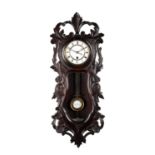 A LATE 19TH CENTURY BLACK FOREST CARVED WALNUT VIENNA WALL CLOCK