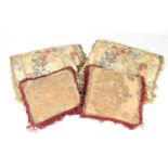 A COLLECTION OF FOUR 17/18TH CENTURY EMBROIDERED CUSHIONS