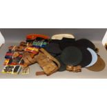 A collection of military Berets, leather belts and related items