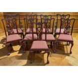 A set of nine Chippendale style dining chairs to include two armchairs, all with pierced carved