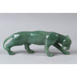 A FABERGE STYLE CARVED JADE MODEL OF A TIGER, with gold and ruby eyes, in a fitted case. 26cms