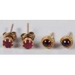 A PAIR OF YELLOW METAL AND RUBY EAR STUDS, and a pair of similar cabochon ear studs.