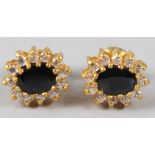 A PAIR OF YELLOW METAL, SAPPHIRE AND DIAMOND OVAL SHAPE EAR STUDS. 11mm x 8mm.
