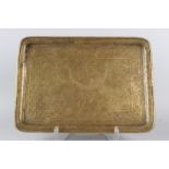 A 19TH CENTURY PERSIAN QAJAR BRASS TRAY engraved with figural decoration. 51cms x 36cms