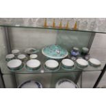 A shelf of Chinese soup bowls and other items.