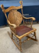 Unusual early 20th century rocking chair with carved back