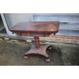 A Regency rosewood fold-over tea table with carved frieze, on turned and carved column and