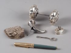 A silver clip with embossed figure decoration, a white metal salt formed as a cornucopia, stamped "