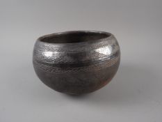 A South African brown glazed pottery beer pot/Ukhamba, with scratch decoration to the border, 7"