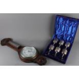 An aneroid barometer and a set of six brass goblets, in box