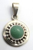 A silver and jade pendant of roundel for