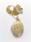 A gold plated silver locket on chain.