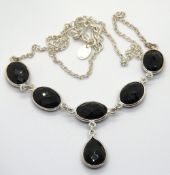 A silver and black onyx necklace, five o