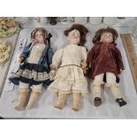 A bisque headed 390 doll by Armand Marseille together with two other bisque headed dolls
