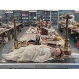 A pair of brass hexagonal column candlesticks on domed feet together with a German bisque headed