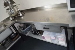 A stainless steel preparation table, width 218cm, depth 68cm, height 86cm together with a