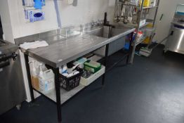 A stainless steel wash station, large sink together with drain off area, width 214cm, depth approx