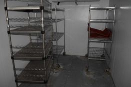 Three stainless steel storage racks of varying heights and designs