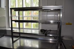 A professional/commercial heated cupboard with a quartz lamp heating gantry, three tiered on top,