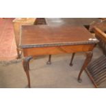 A Georgian mahogany card table of hinged rectangular form raised on tapering legs with ball and claw
