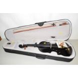 A modern high gloss finish violin, no makers label apparent, together with bow and carry case