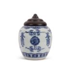 A Chinese porcelain ginger jar with wooden cover, decorated in blue and white with double concentric