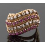 An 18ct diamond and ruby ring, set with four alternating curving diagonal rows of rubies and