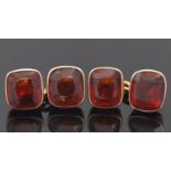 A pair of hessonite garnet cufflinks, each cufflink set with two cushion cut hessonite garnets, each