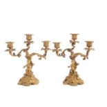 A pair of 19th Century continental gilt bronze three light candelabras, the scrolled arms