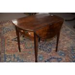 A Georgian mahogany Pembroke table with oval drop leaf top over a single frieze drawer raised on