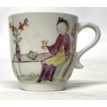 A Lowestoft coffee cup with polychrome decoration of Chinese figures by a table