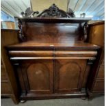 A Victorian mahogany chiffonier with a scrolled pediment over a single shelf and swans head