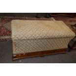 A Victorian walnut and floral upholstered ottoman, the hinged lid over a body of slightly waisted