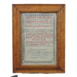 A 19th century needlework sampler, with alpha-numeric stictching and patterned border, names Jane