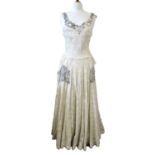 A 1930/40's lace dress, the sleeveless cream lace overlay dress with rounded neck and beaded detail,