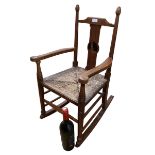 Edwardian, Arts & Craft child's Oak rocking chair, possibly for Liberty & Co, the splat inlaid