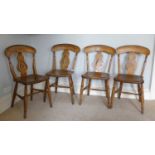 A set of four 19th century provincial elm beech and fruitwood bar back kitchen chairs, each having