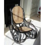 After Thonet - an ebonised bentwood rocking chair, with split cane back and seat, w.48cm