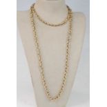 A 9ct yellow gold long guard chain, with textured bow and circular links, length 760mm, chain