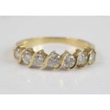 An 18ct yellow gold diamond half eternity ring, featuring seven round brilliant cut diamonds in wavy