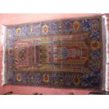 A Persian woollen red and blue ground prayer rug, with flatweave ends, 142 x 89cm