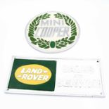 A reproduction metal Mini Cooper sign, dia.24cm, together with a Land Rover sales and service