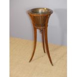 An Edwardian mahogany and satinwood inlaid circular plant stand, having removable brass liner,