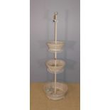 A painted pierced metal circular three-tier plant stand, h.177cm