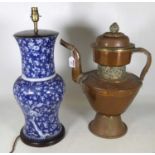 A Tibetan copper teapot of large proportions, with applied pierced metal decoration, h.50cm,