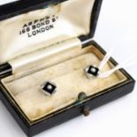 A pair of 9 carat white gold collar studs, each set with an onyx panel and seed pearl, stamped