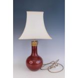 A Chinese copper-red glazed vase converted into a table lamp, Qing Dynasty Of bottle form, with a