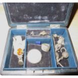 Small leather jewelery box containing an enamel decorated silver brooch, Scottish silver and topaz