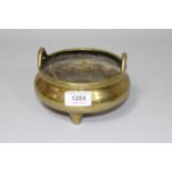 19th Century Chinese bronze censer of circular squat, two handled baluster form, 15cm diameter,