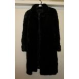 Ladies 3/4 length black fur coat by Oglivy's, Montreal, together with a 3/4 length mid brown fur